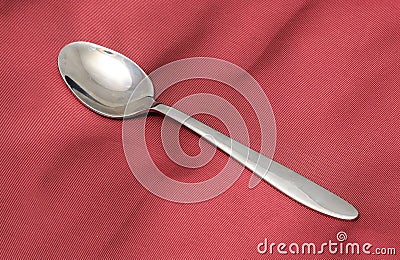 Teaspoon on Red Silk Stock Photo