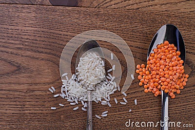 Teaspoon of rice and tablespoon of orange lentils. Stock Photo