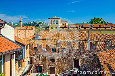 Teatro Nuovo theatre courtyard, brick wall with merlons and red tiled roof Stock Photo