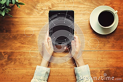 Tech circle with a person holding a tablet Stock Photo