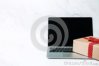 Tech gifts for Christmas for the tech-obsessed person. Gadgets and devices Xmas gift ideas. Laptop with Christmas Gift Editorial Stock Photo