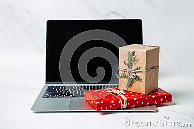 Tech gifts for Christmas for the tech-obsessed person. Gadgets and devices Xmas gift ideas. Laptop with Christmas Gift Editorial Stock Photo