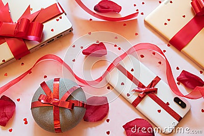 tech gifts wrapped with red gift bows Stock Photo