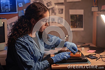 technical check problem for laptop computer with multimeter. Female repairman disassembling laptop motherboard. Engineer Stock Photo