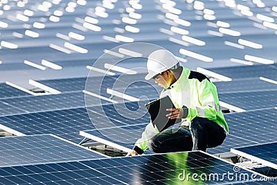 Technical expert in solar energy photovoltaic panels, remote control performs routine actions for system monitoring using clean, Stock Photo