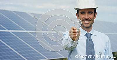 Technical expert in solar energy photovoltaic panels, remote control performs routine actions for system monitoring using clean, r Stock Photo