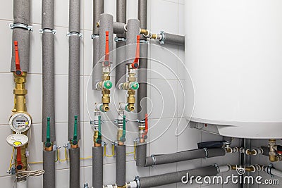 white boiler for water heating and piping system with grey pipe Stock Photo
