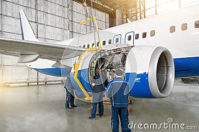 Technical specialists and aircraft mechanics install the reverse engine. Concept maintenance of airplane Editorial Stock Photo