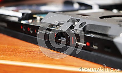 A geek cleans a laptop cooler. Contaminated computer cooling system. Stock Photo