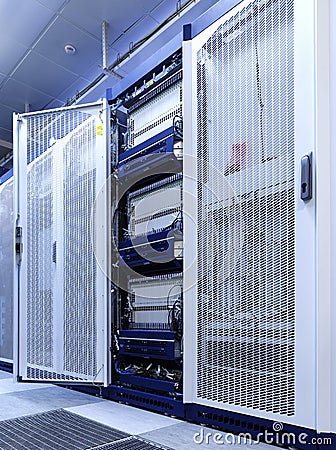 Technical wall of cellular data terminal rows with opened mesh door Stock Photo