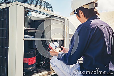 Technician is checking air conditioner Stock Photo