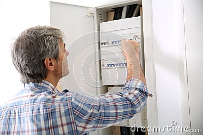 Technician checking on electric box at home Stock Photo