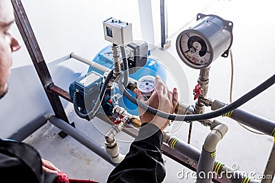 Technician checking water system nodes.Modern Industrial background Stock Photo