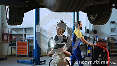 Technician checks car from underneath Stock Photo