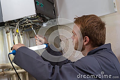 Technician controlling the heating system Stock Photo