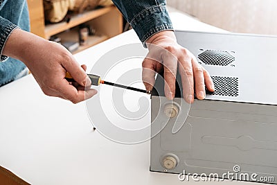 Technician disassemble computer with a screwdriver for problems diagnostic Stock Photo