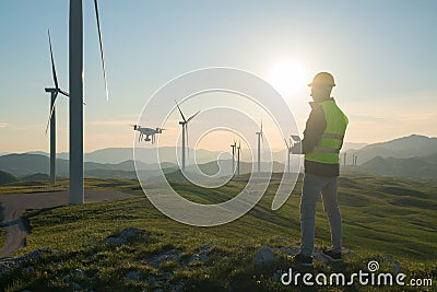 Technician Engineer in Wind Turbine Power Generator Station launches a drone for visual control of generators Stock Photo