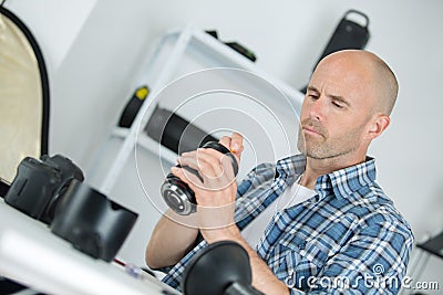 Technician examining and repairing dslr camera Stock Photo