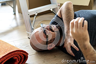 A technician falling off from a ladder Stock Photo