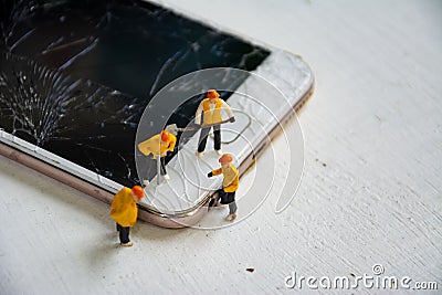 Technician figurine model repair mobile display screen crack broken Stock Photo