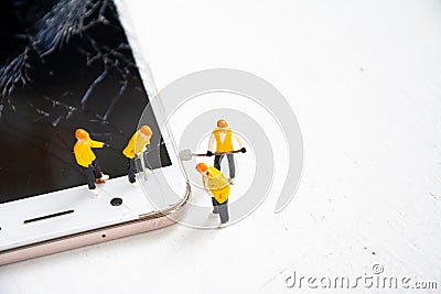 Technician figurine model repair mobile display screen crack broken Stock Photo