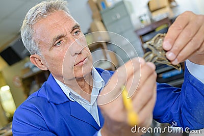 Technician holding mechanical part Stock Photo