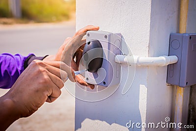 Technician installed and test motion sensor to control gate for motor automatic gate home security system Stock Photo