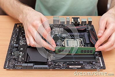 Technician Installing random access memory into PC. Stock Photo