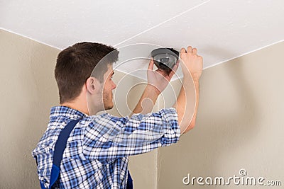 Technician Installing Surveillance Camera Stock Photo