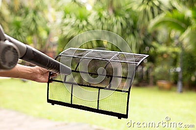 Technician man dry up and dust cleaning air Conditioner filter w Stock Photo