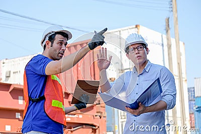 Technician and manager argue with the problem in cargo containers shipping area Stock Photo