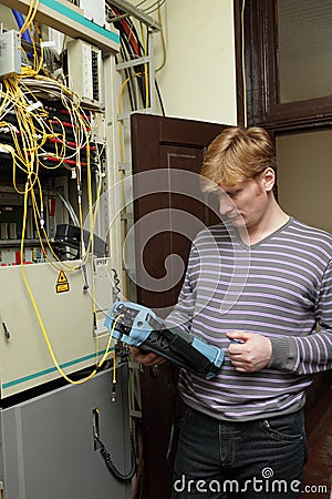 Technician measuring fiber optic Stock Photo