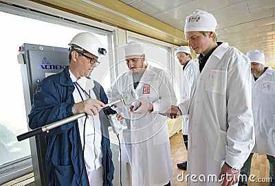 Technician measuring levels of radiation on journalists equipment after visiting Chernobyl Nuclear Power Plant building Editorial Stock Photo