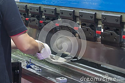 The technician operator use hydraulic bending machine. Stock Photo