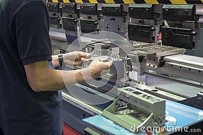 The technician operator use hydraulic bending machine. Stock Photo