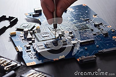 Technician plug in CPU microprocessor to computer motherboard Stock Photo