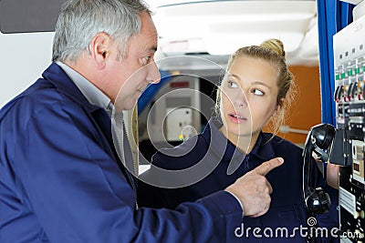technician pointing at telephone on panel Stock Photo