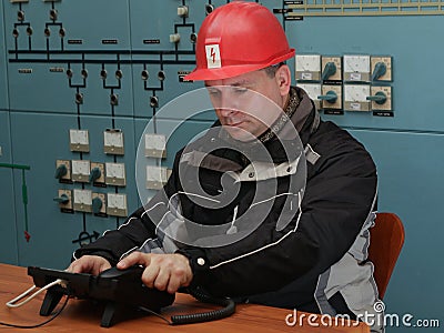 Technician prepare to make phone call in the power plant contr Stock Photo