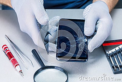 Technician preparing to repair and replace new screen broken and cracked screen smartphone. Stock Photo