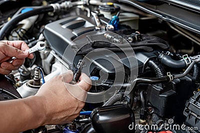 Technician Removing the gasoline injector part in engine room check dust and test pressure Stock Photo