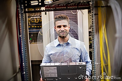 Technician removing server from rack mounted server Stock Photo