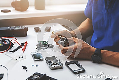 Technician repairing broken digital camera lens Stock Photo