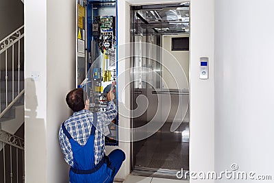 Technician Repairing Elevator Stock Photo