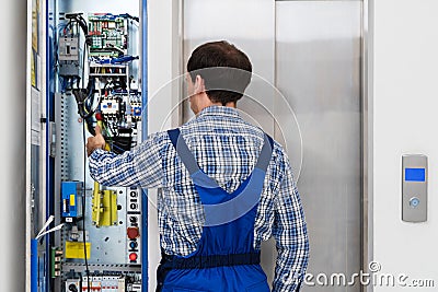 Technician Repairing Elevator Stock Photo