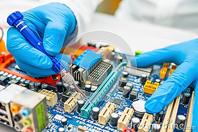 Technician repairing inside of hard disk by soldering iron. Integrated Circuit. Stock Photo