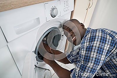 Technician Repairing Washing Machine Stock Photo