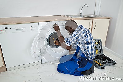 Technician Repairing Washing Machine Stock Photo