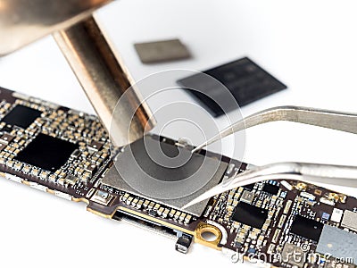 Technician replacing flash storage of smartphone motherboard Stock Photo