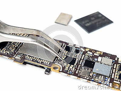 Technician replacing microchip of smartphone logic board Stock Photo