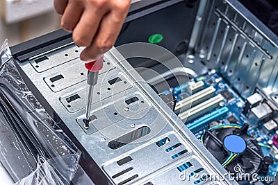 Technician's hand assembling personal computer Stock Photo